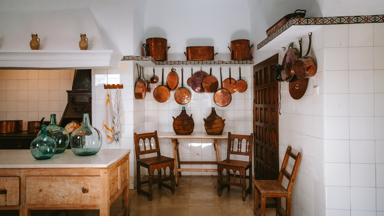 A rustic kitchen with hanging pots and pans
