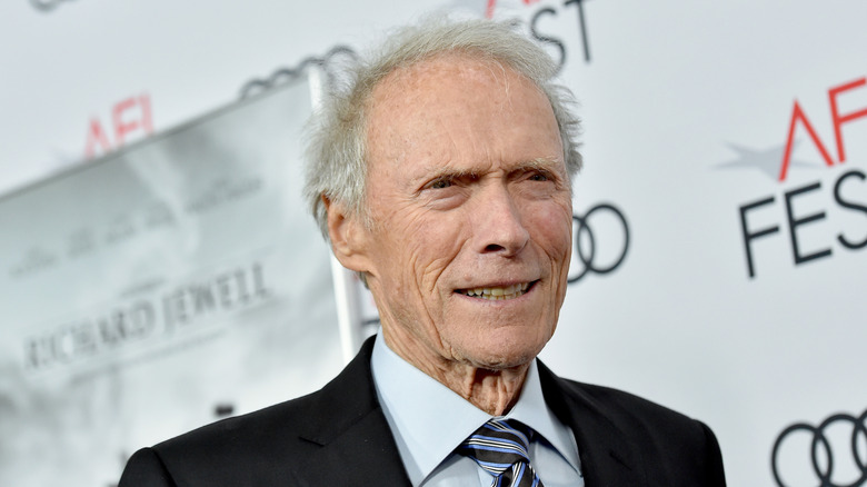 Clint Eastwood smiling on a red carpet