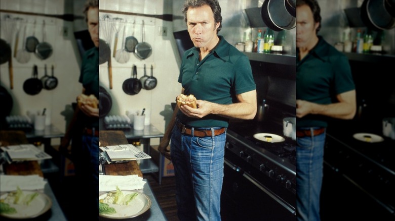Clint Eastwood eating a sandwich in his kitchen
