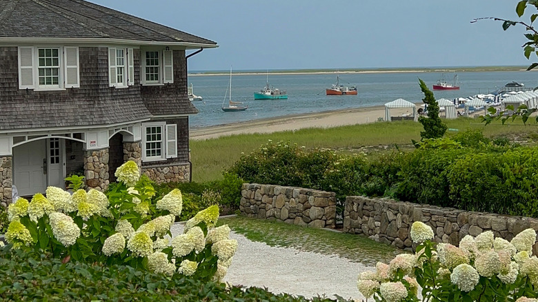 Large coastal home with hydrangeas and other shrubs