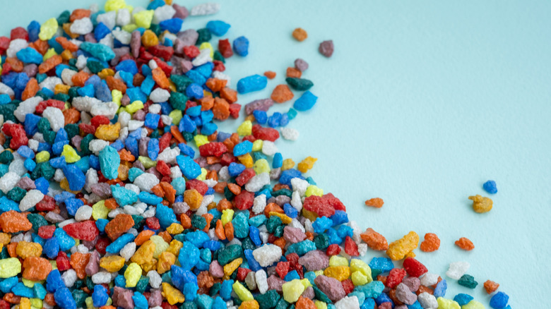 Pile of colorful aquarium rock on a blue surface