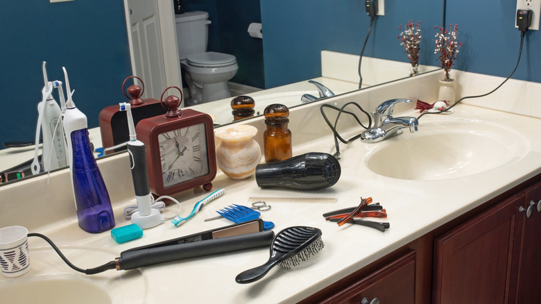 messy bathroom counter full of items