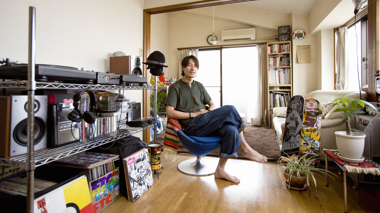 man sitting in personalized apartment