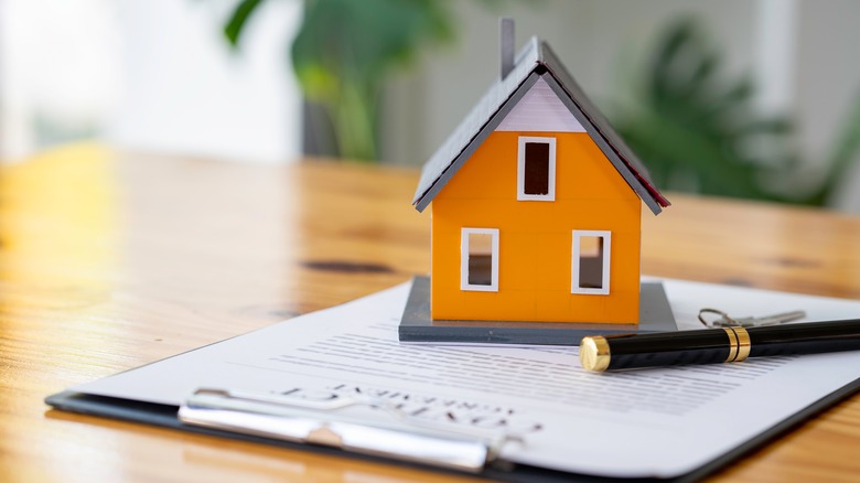 house on top of paperwork