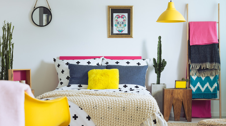 Asymmetrical bedroom decorated in a modern folk style