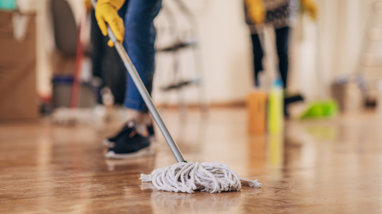 Person mopping hardwood floor