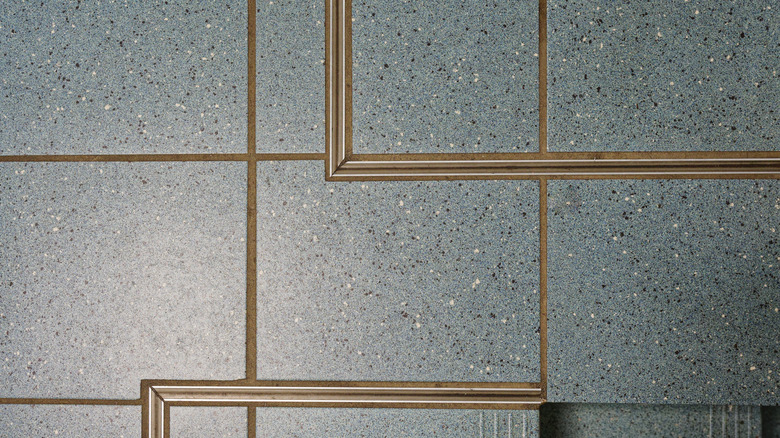Expansion joint shown in blue ceramic kitchen tile flooring