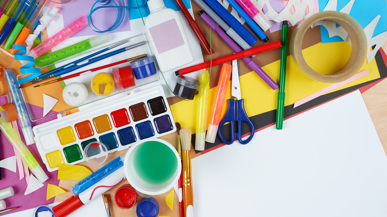 Various arts and crafts supplies, like paint and construction paper.