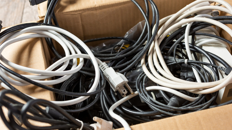 Cardboard box filled with charging cables.