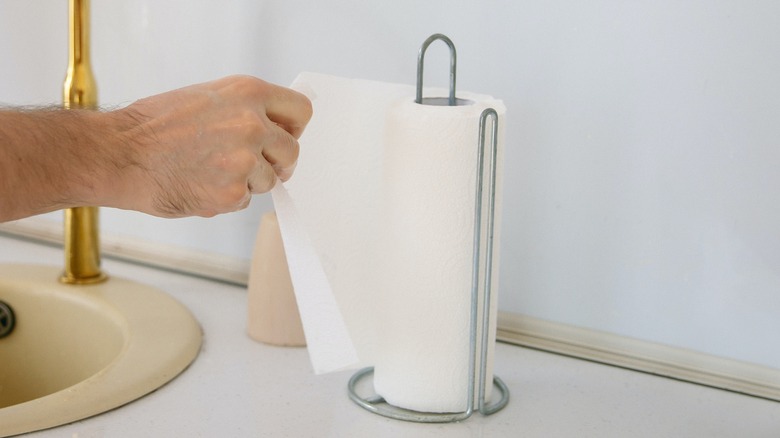 hand pulling paper towel