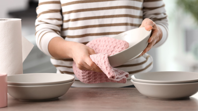 wiping bowls with pink towel