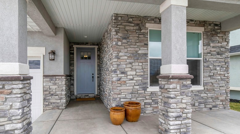 The front of a house with gray stone veneer.