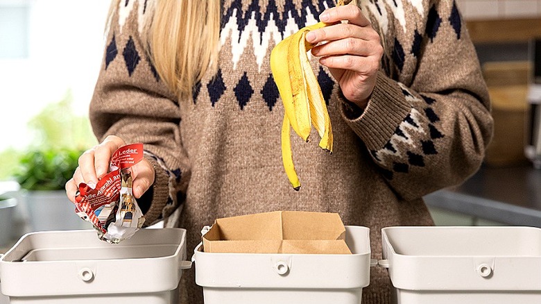 Person is organizing recyclable materials at home, placing banana peels and packaging into designated bins, encouraging sustainable living habits