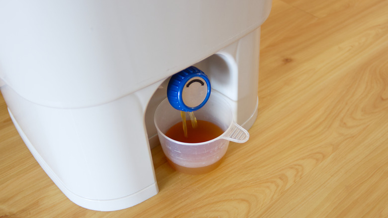 liquid compost pouring into cup