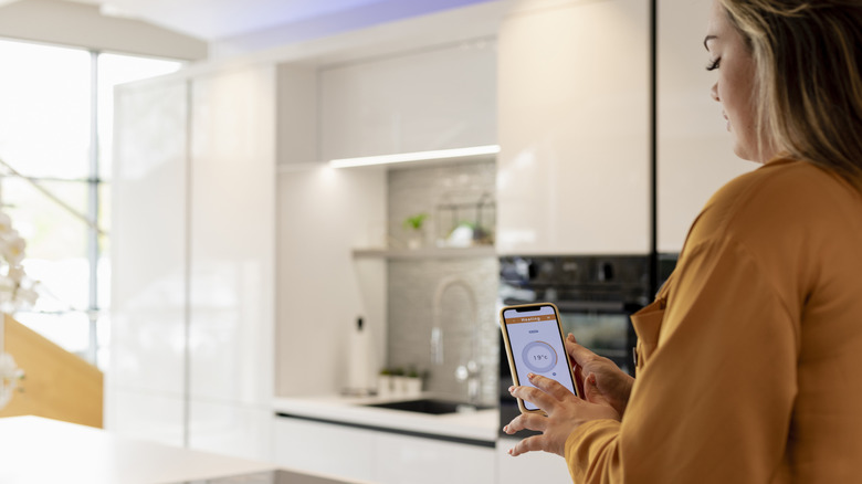 Woman using smart home app on her phone