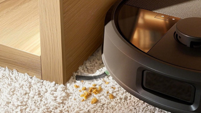 The iRobot Roomba Max 705 vacuuming crumbs on carpet