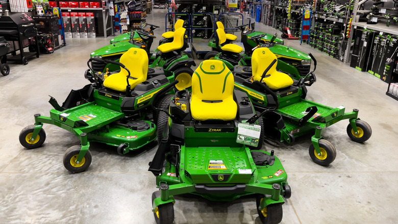John Deere zero-turn mowers on display in a home and garden store