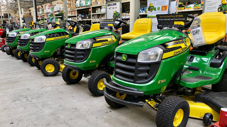 John Deere riding mowers on display in a home and garden store