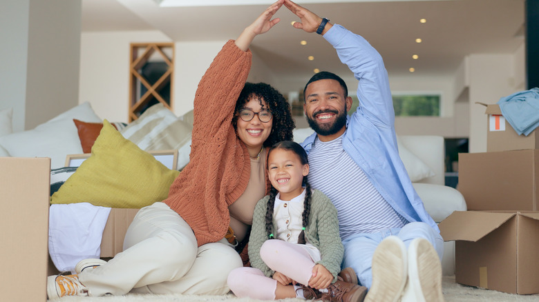 family in home making house gesture