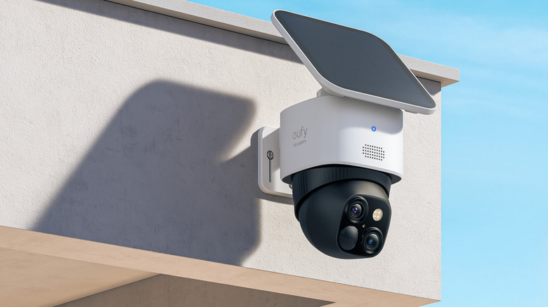a eufy s340 solor cam with a solar panel sits on the corner of a house