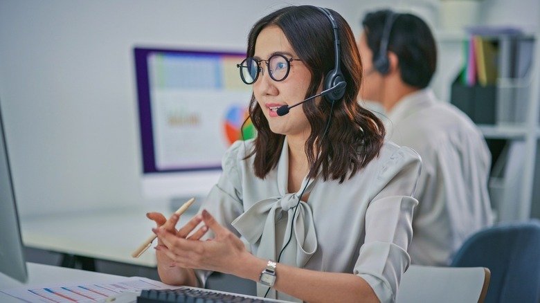 An online customer service agent speaking to a customer through their headphones