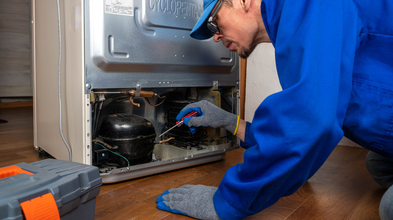 Repairman working on a refrigerator