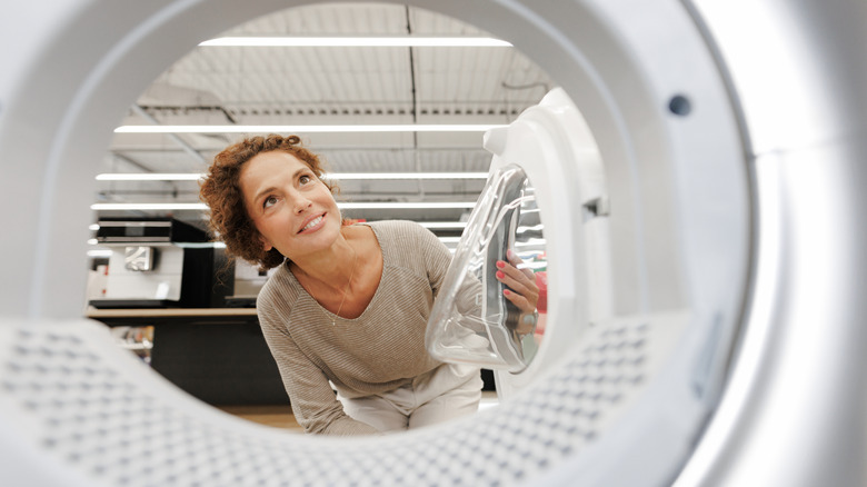 Woman looking inside a washing machine