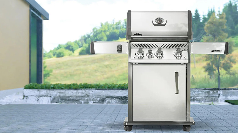 The Napoleon Rogue PRO 425 gas grill in a stainless steel finish on a patio