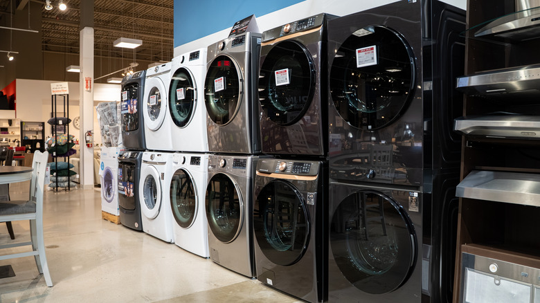 View of washing machines and dryers displayed in a home appliance store