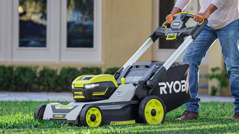A man mowing a lawn with a Ryobi 40V HP 21" Whisper Series Walk-Behind Lawn Mower