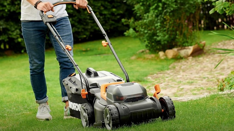 Person using a Worx battery-powered mower