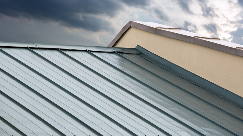 A metal roof with flashing on adjacent wall