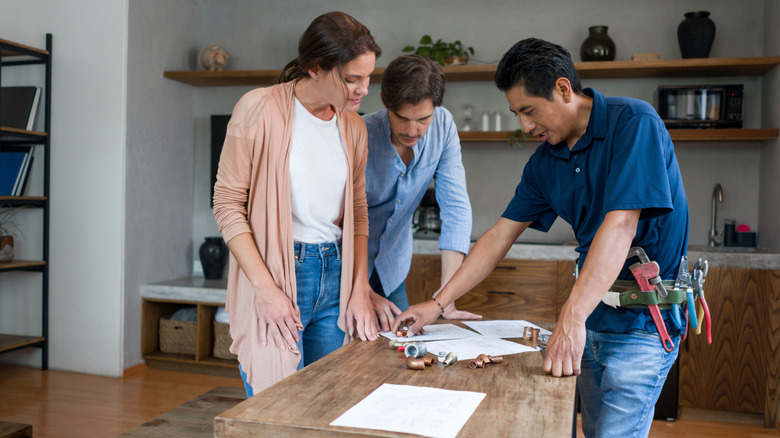 contractor talking with couple