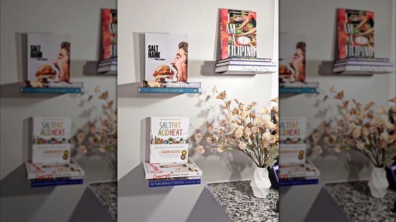 Cookbooks displayed on small, transparent floating shelves.