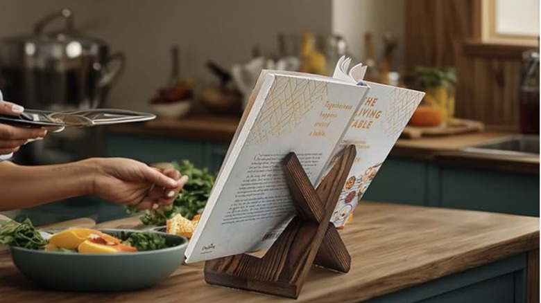 A recipe book propped open on a wooden easel.