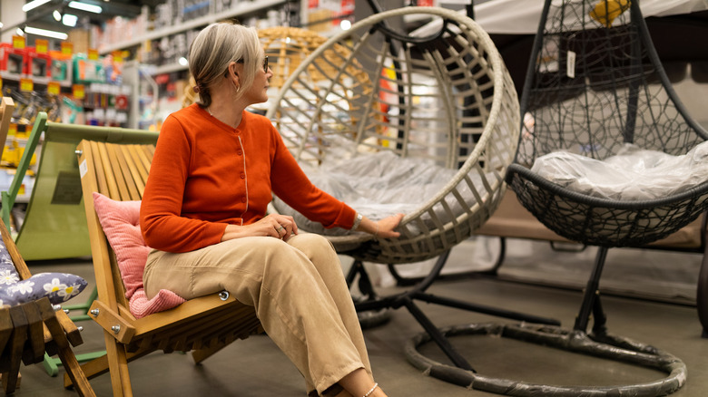 Woman testing out patio furniture in store