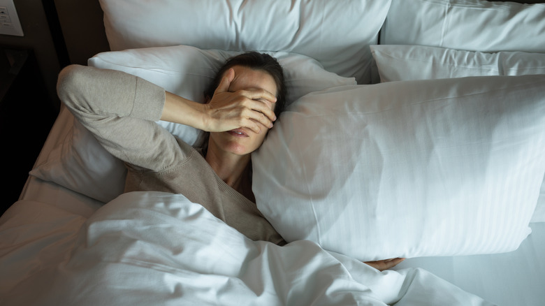 a woman unable to sleep in bed