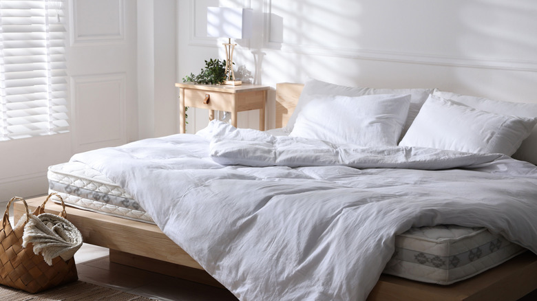 White duvet on a bed in a brightly lit bedroom