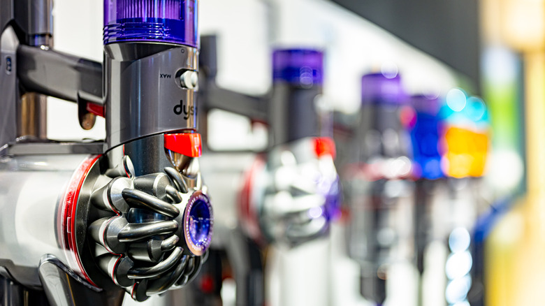 Dyson vacuums lined up in a store display