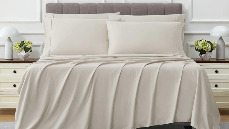 Beige sheets on a bed