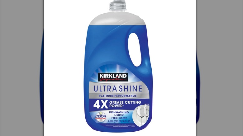 A blue bottle of Kirkland Ultra Shine dish soap against a white background