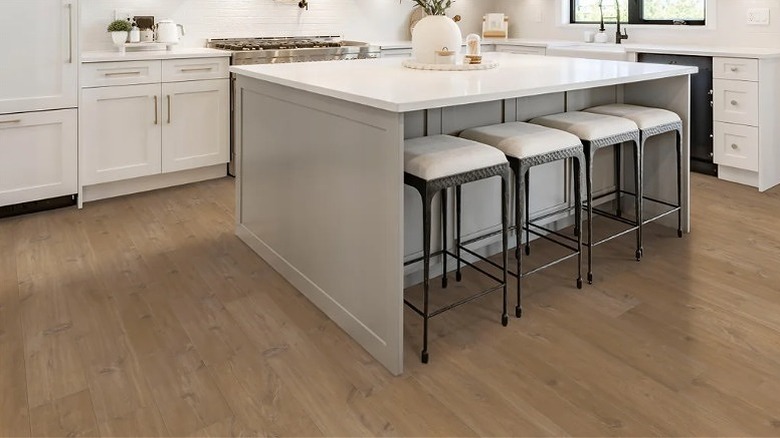 United Weavers WPC flooring in a kitchen with white cabinets.