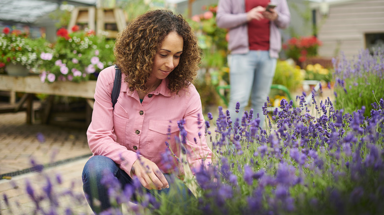 A woman shopping for plants at a garden center