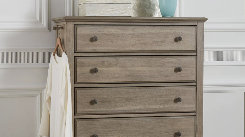 The Serenity chest with a white shirt hanging on a hanger on the valet rod