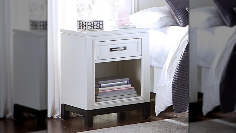 The Noah nightstand next to a bed in a bedroom