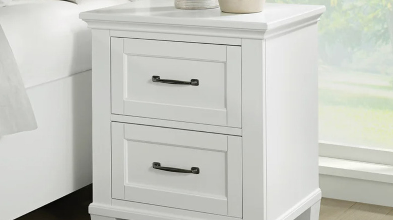 Rose nightstand sitting next to a bed