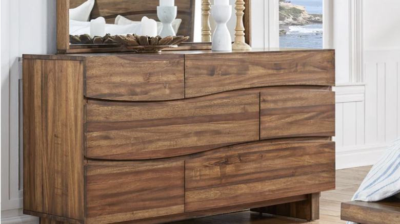 The Rivina dresser and floating mirror in a bedroom with white walls