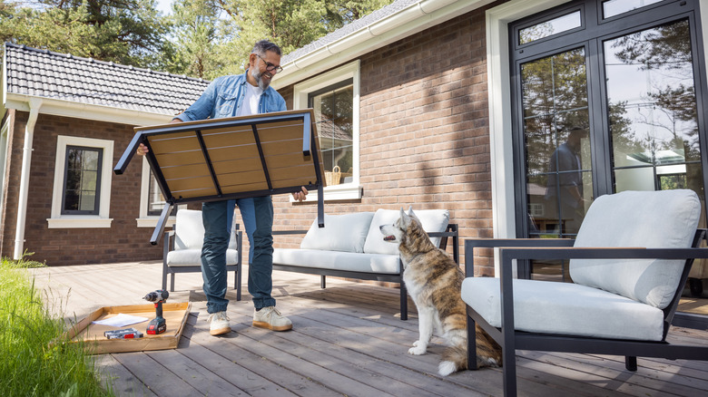 A man assembling a new patio furniture set