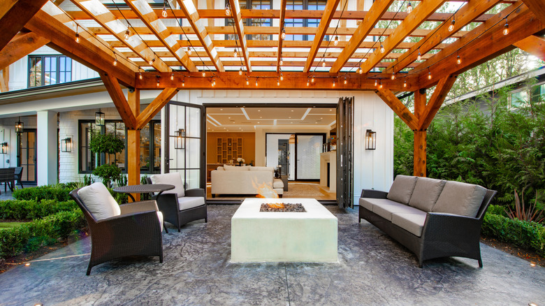 A fashionable patio with a four piece set and a firepit