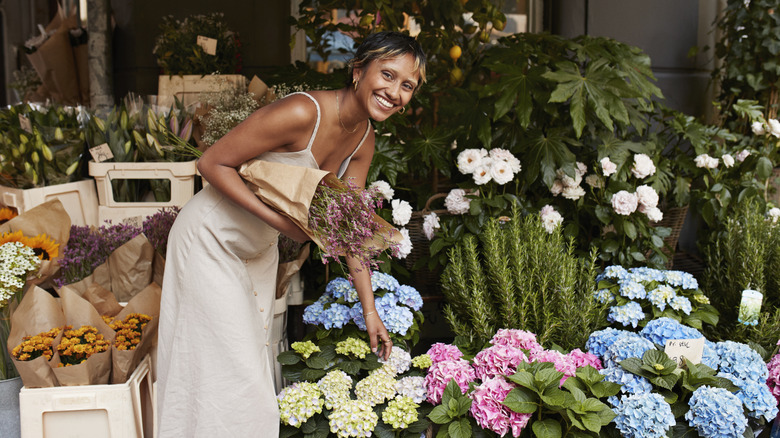 A woman shopping for hydrangeas in a store
